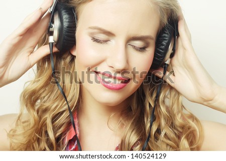 Rock style woman with headphones listening to music