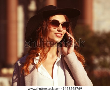 smiling young woman calling and talking on smartphone in the aut Stock fotó © 
