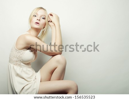 fashion beautiful blonde model sitting on a stool