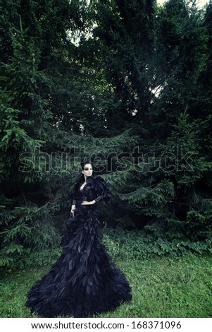 Dark Queen in park. Fantasy black dress.