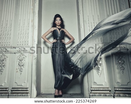 young elegance woman with flying dress in palace room