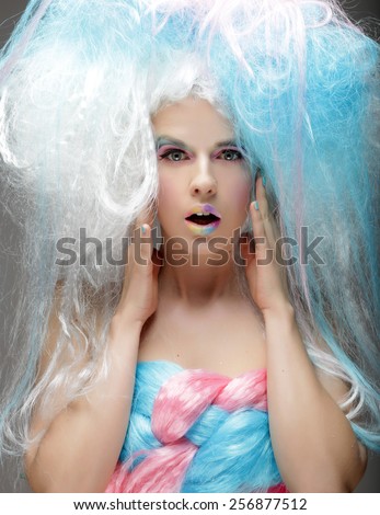Young fashion model with bright make up and colorful hair