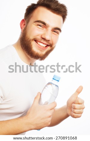Fitness, sport  and lifestyle concept: smiling muscular sportive man wearing white shirt with bottle of water. Isolated on white.