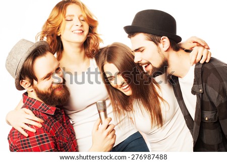 People, friendship  and leisure concept: group of young happy friends  having fun at karaoke, hipster style.Isolated on white.