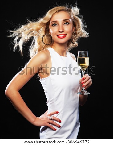 smiling woman in evening dress with glass of sparkling wine