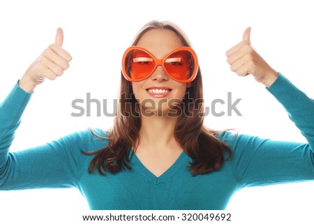Party image. Playful young woman with big party glasses. Ready for good time