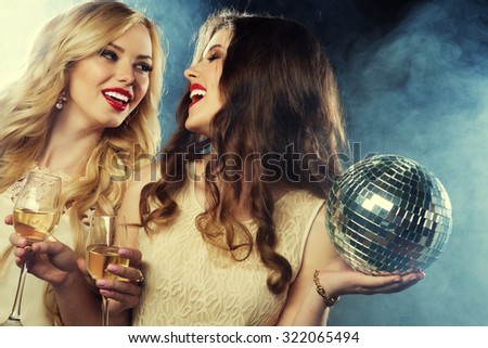 two beautiful young women with wine glasses and disco ball.