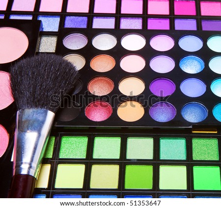 multicolored eye shadows with cosmetics brush