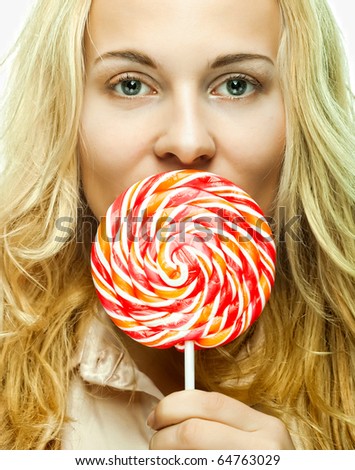 Pretty young woman holding lolly pop. Isolated on white.