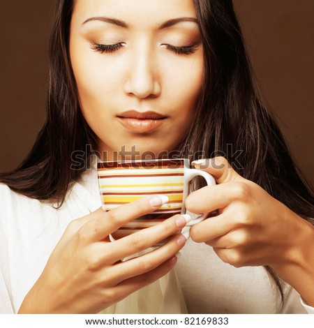Beautiful asian woman drinking coffee or tea