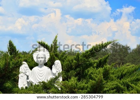 Christian stone marble Angel in forest at church
