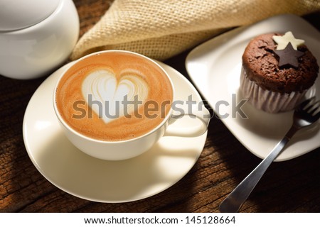 A cup of cafe latte and cake