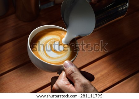 Making of cafe latte art, tulip shape