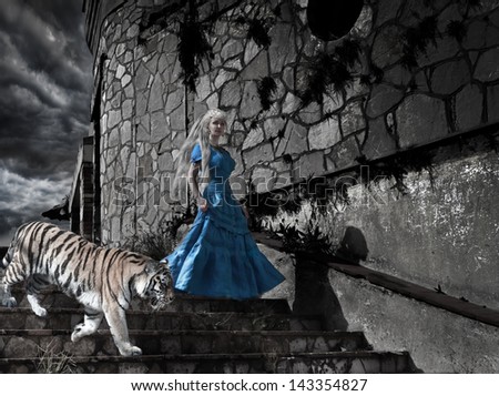 Magic scene- fantastic princess from fairy tale with a tiger on old tower steps