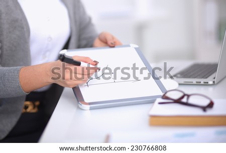 Beautiful businesswoman handing over paperwork extending her hand