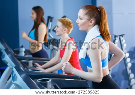 Group of people at the gym exercising on cross trainers