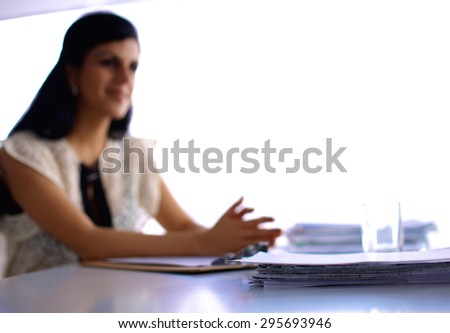 Woman with documents sitting on the desk