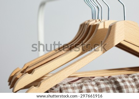 Clothes hang on a shelf in  designer clothes store
