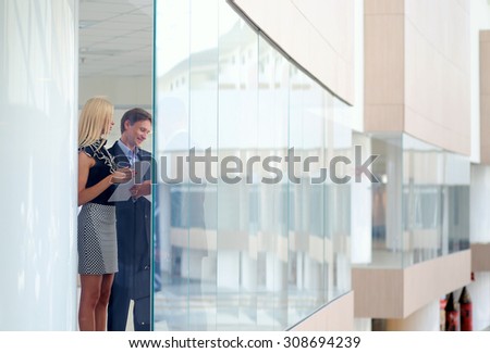 Business woman standing with her staff in background at modern office