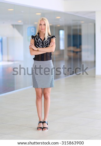Portrait of a beautiful office worker standing in an office
