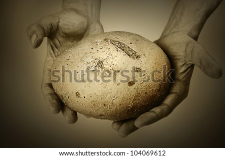 Image of man hands  with a loaf of bread stylized like vintage photo