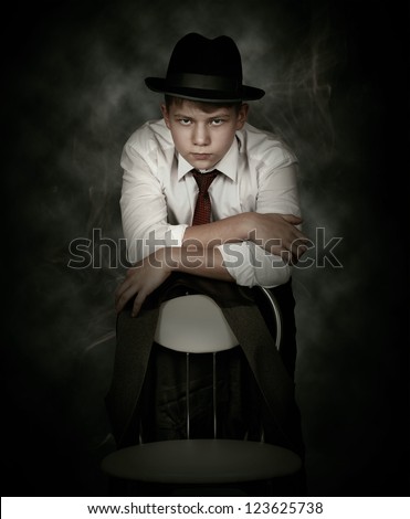 Portrait looking danger young man in gangster retro style