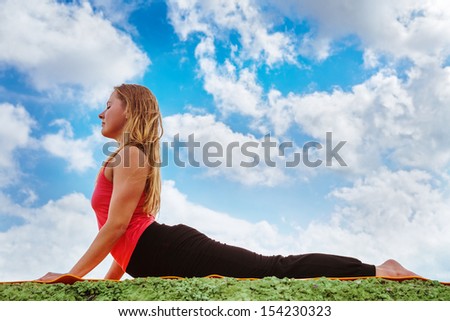 Yoga outdoor practice.Young woman show cobra yoga pose perfectly