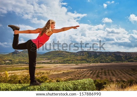 Yoga outdoor. Beautiful slim girl  make king of dance yoga pose