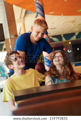 Three teens friends in cozy cafe