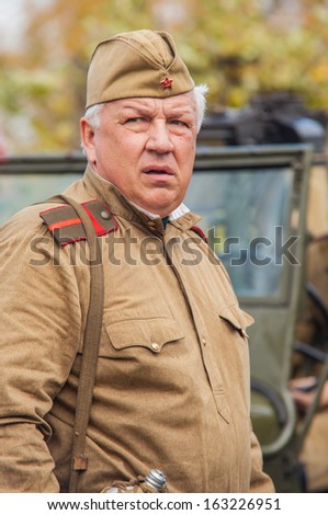 DNIPRODZERZHYNSK, UKRAINE - OCTOBER 26 :  Member of Historical reenactment in Soviet Army uniform after battle on October 26,2013 in Dniprodzerzhynsk, Ukraine. Dniprodzerzhynsk Liberation Day 2013