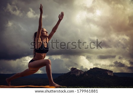 Young slim woman makes Syrya Namaskara yoga poses sequence