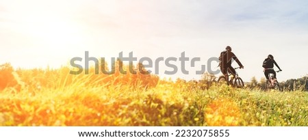 Similar – Image, Stock Photo Active sporty couple riding mountain bikes on demanding forest trail.