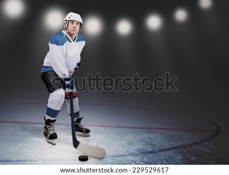 Hockey player on the ice in arena lights