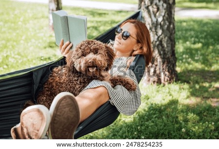 Similar – Image, Stock Photo caucasian woman and dog in park in springtime at sunset. Love and friendship concept. pets outdoors