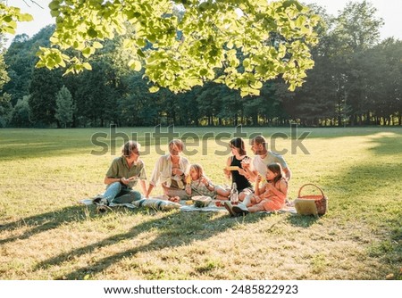 Similar – Image, Stock Photo Family sitting outdoors with dog