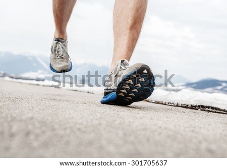 Close up image runner legs in running shoes
