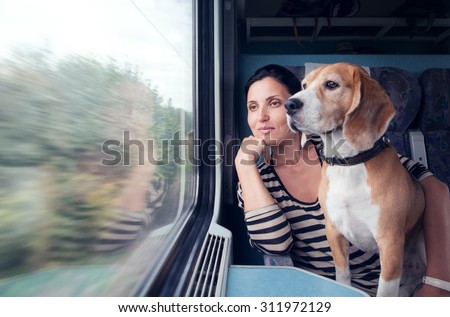Woman with his dog travel in railway wagon