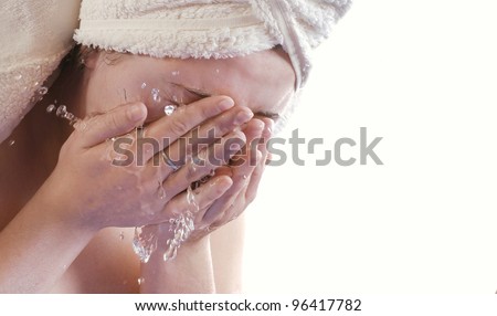 Close-up view of the girl wash her face with water