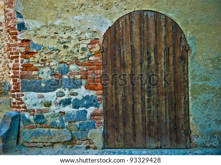 Old wooden door from medieval era, Ricetto di Candelo, Biella, Italy