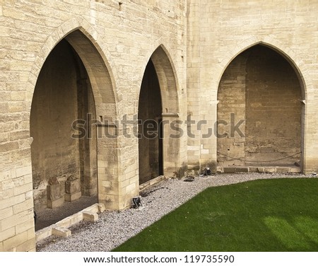 Arched wall around a courtyard in the Popes\' Palace in the walled city of Avignon in the Provence Section of the South of France