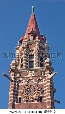 Stone and brick church steeple with red roof and clock in Paterson, NJ.