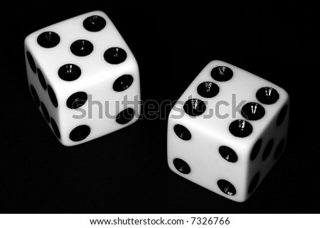 Black and white image of a pair of dice thrown with the number eleven.