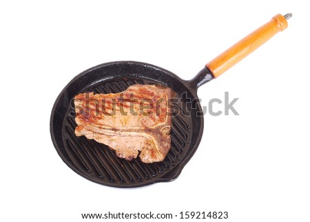 A big sirloin and rump beef steak with T-bone sizzling in a hot pan. Image isolated on white studio background.