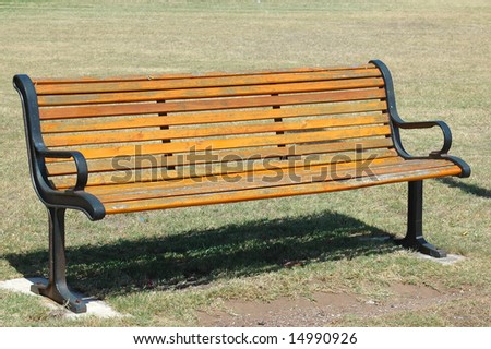 A beautiful vintage wooden empty bench to sit on in a park outdoors