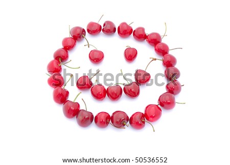 Lots of red ripe fresh cherries in funny smiley face shape. Image isolated on white studio background.