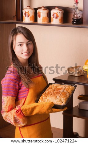 beautiful girl with cake in kitchen