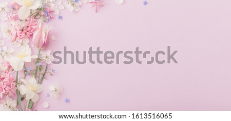 Photo of beautiful spring flowers on paper background