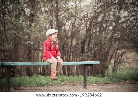 funny girl on bench in spring park