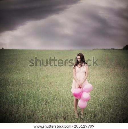 beautiful young women with pink balloons outdoor