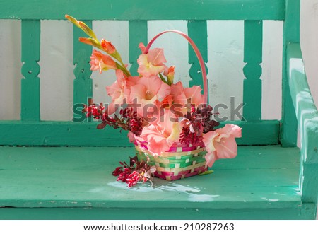 flowers in basket  on bench indoor
